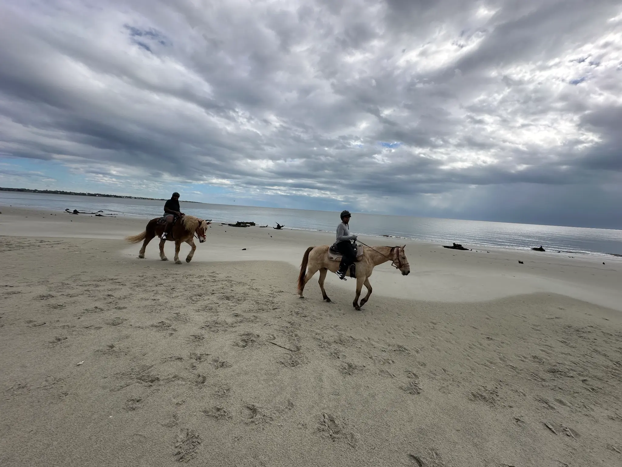 Atiyah and her son horseback riding along the beach